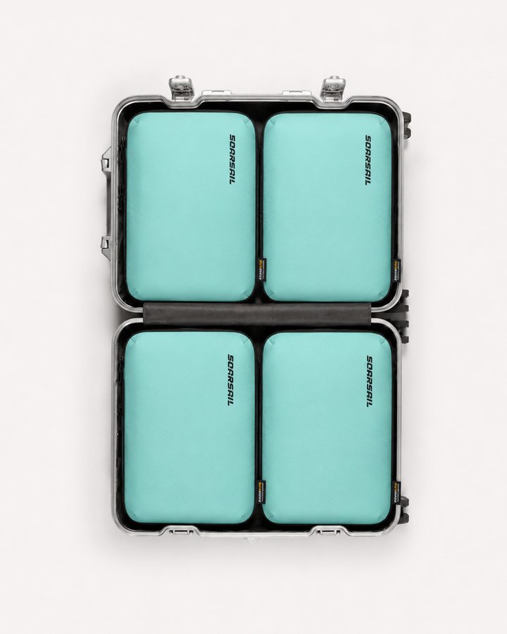 Four SOARSAIL compression cubes neatly organized inside a suitcase